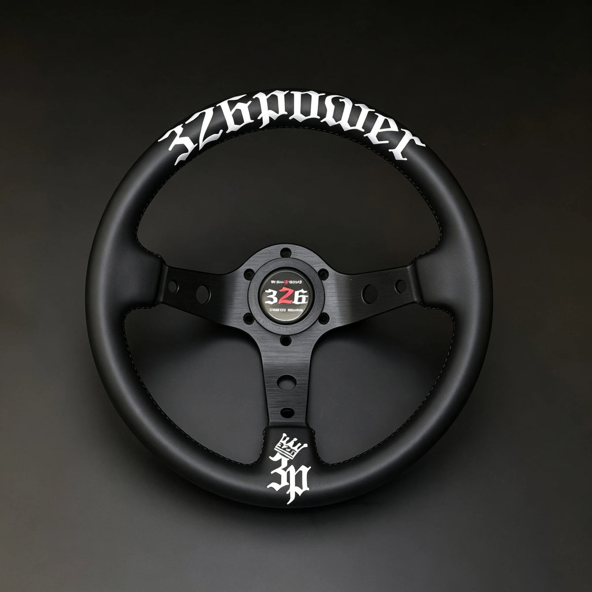A black multi-spoke racing steering wheel featuring white gothic-style lettering that reads '3Z6power' on the upper rim and a matching '3Z6' logo on the center cap, set against a dark gray background.